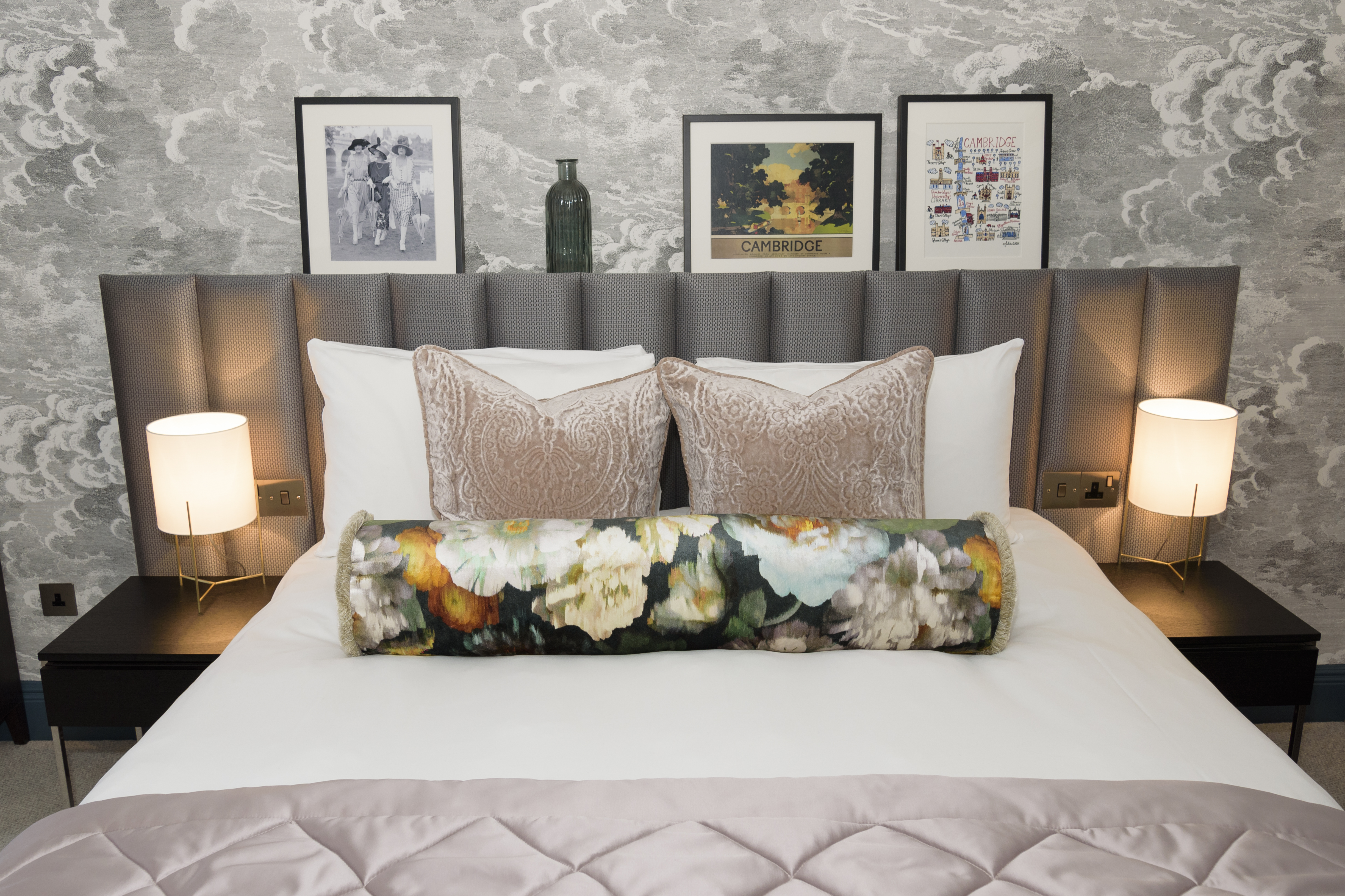 Elegant classic bedroom at the Gonville Hotel, Cambridge, featuring soft neutral tones, a plush headboard, bedside tables, and framed prints.