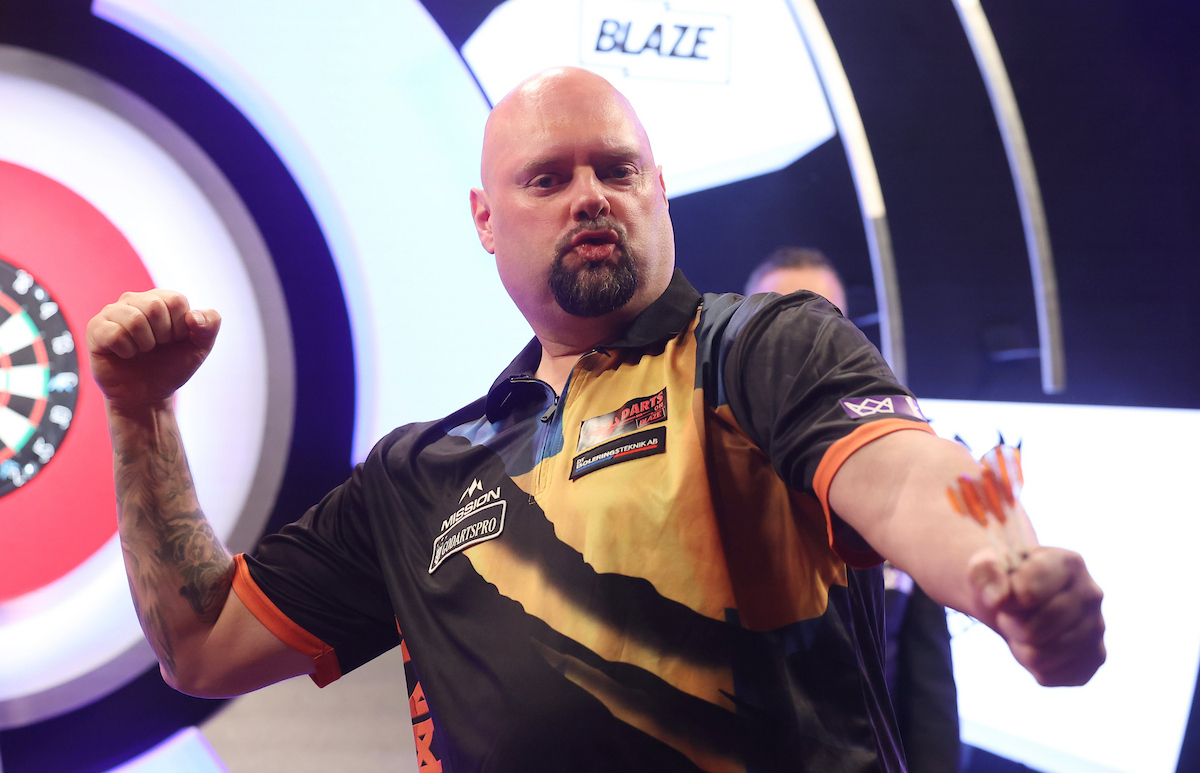 Player posing with darts at the WDF tournament, Lakeside Country Club in Frimley Green—one of the best events in Surrey.